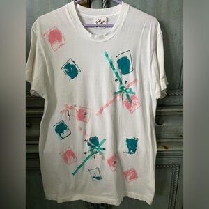 Long white t-shirt w/ green and pink ribbons, bows and sequins.
